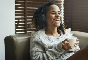 Woman enjoying music on her sofa